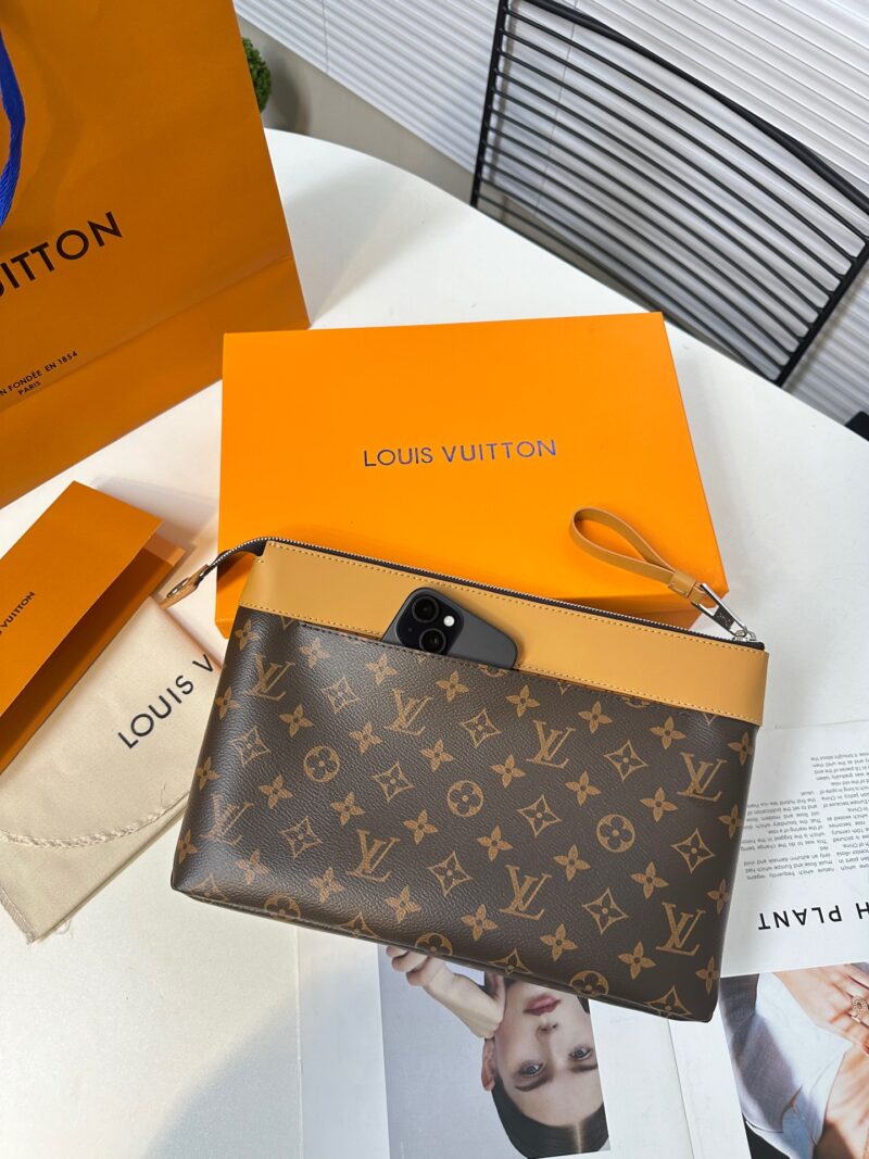 2b30f50dda.jpg Exclusive real-life shot of M14057 vintage Pochette Voyage Souple handbag with gift box. Made of soft Monogram Eclipse coated canvas, the classic Pochette Voyage handbag lines are outlined with rounded strokes, providing a comfortable and portable ex...