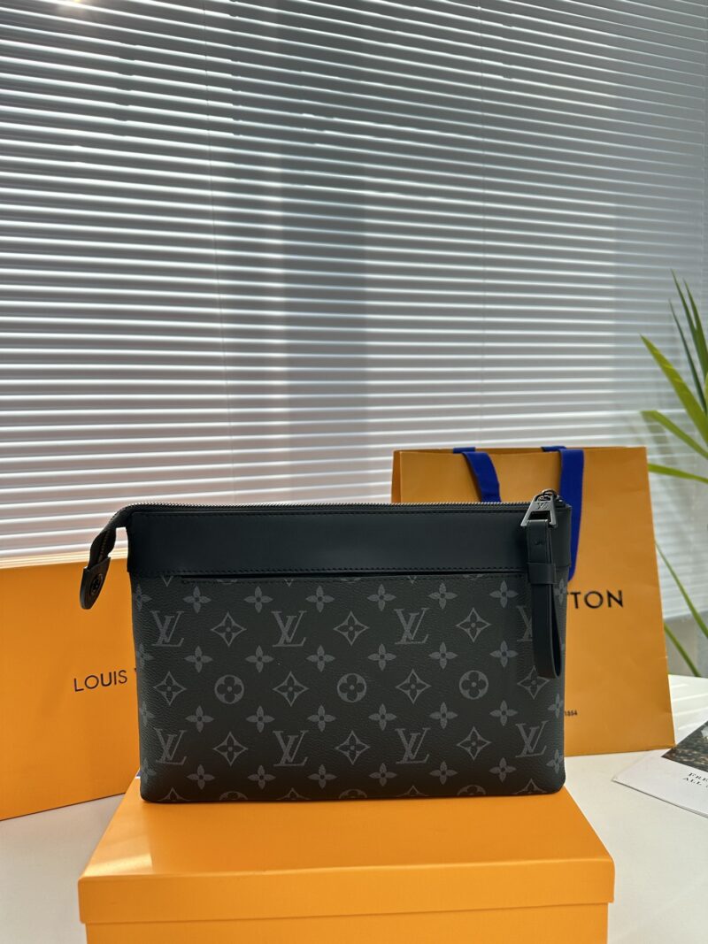 Exclusive real-life shot of M82543 black floral Pochette Voyage Souple handbag with gift box. Made of soft Monogram Eclipse coated canvas, the classic Pochette Voyage handbag lines are outlined with rounded strokes, providing a comfortable and portab...