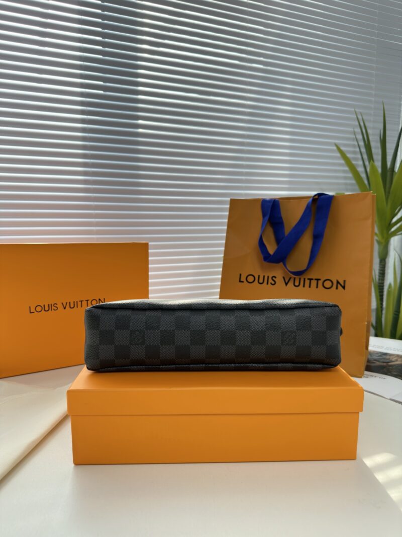 Exclusive real-life shot of M82543 Haige Pochette Voyage Souple handbag with packaging. Made of soft Monogram Eclipse coated canvas, the classic Pochette Voyage handbag lines are outlined with rounded strokes, providing a comfortable travel experienc...