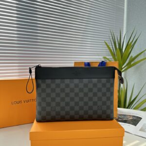 Exclusive real-life shot of M82543 Haige Pochette Voyage Souple handbag with packaging. Made of soft Monogram Eclipse coated canvas, the classic Pochette Voyage handbag lines are outlined with rounded strokes, providing a comfortable travel experienc...