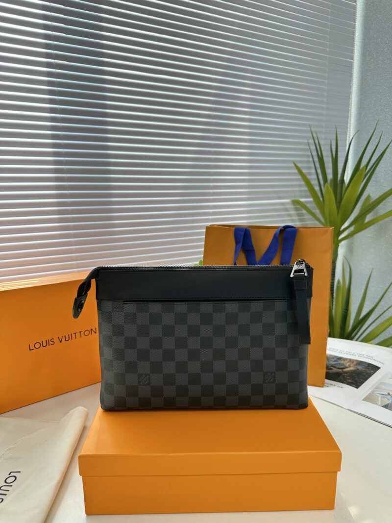 Exclusive real-life shot of M82543 Haige Pochette Voyage Souple handbag with packaging. Made of soft Monogram Eclipse coated canvas, the classic Pochette Voyage handbag lines are outlined with rounded strokes, providing a comfortable travel experienc...