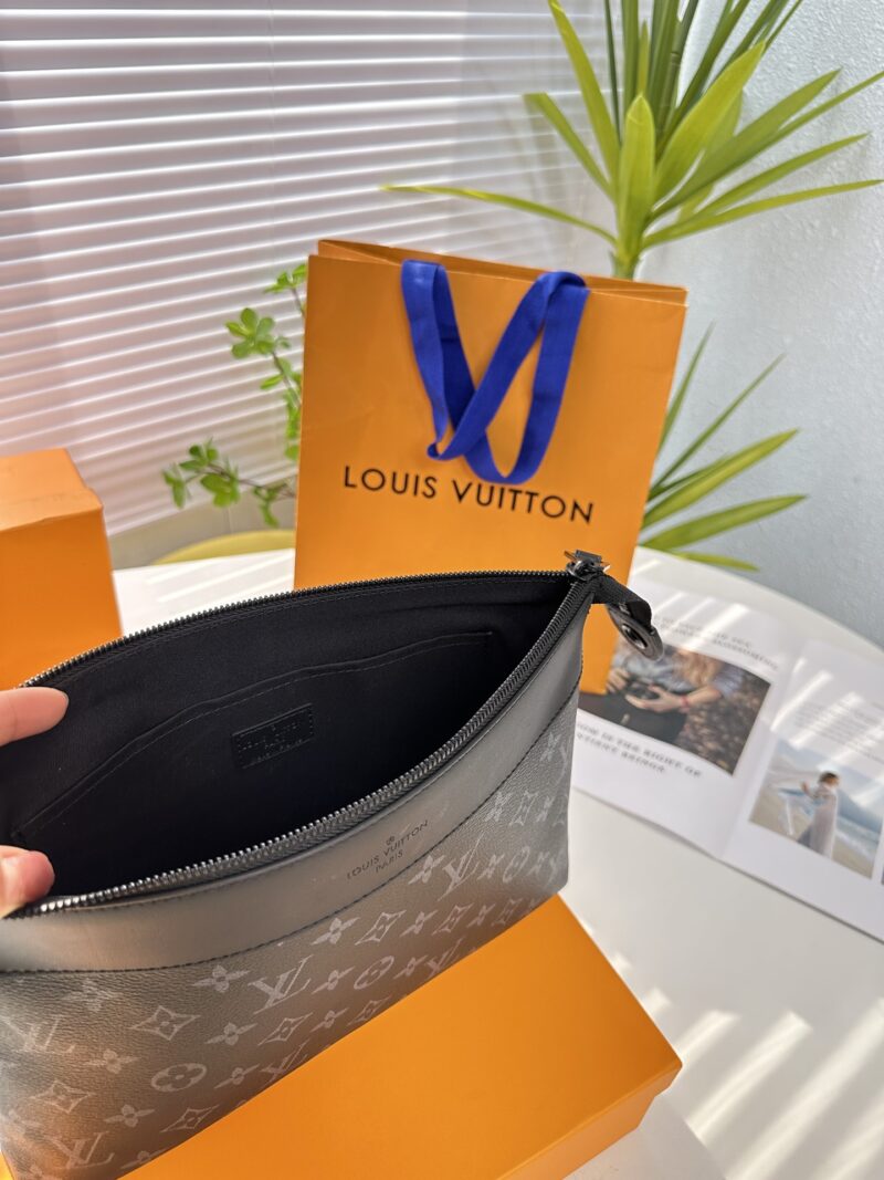Exclusive real-life shot of M82543 black floral Pochette Voyage Souple handbag with gift box. Made of soft Monogram Eclipse coated canvas, the classic Pochette Voyage handbag lines are outlined with rounded strokes, providing a comfortable and portab...