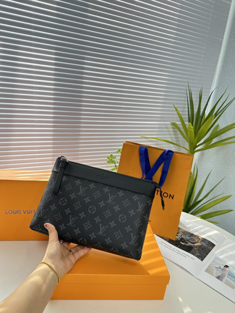 Exclusive real-life shot of M82543 black floral Pochette Voyage Souple handbag with gift box. Made of soft Monogram Eclipse coated canvas, the classic Pochette Voyage handbag lines are outlined with rounded strokes, providing a comfortable and portab...