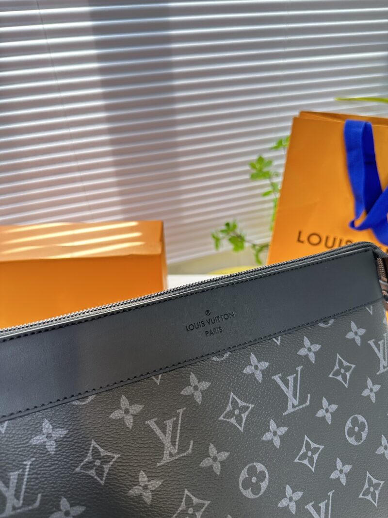Exclusive real-life shot of M82543 black floral Pochette Voyage Souple handbag with gift box. Made of soft Monogram Eclipse coated canvas, the classic Pochette Voyage handbag lines are outlined with rounded strokes, providing a comfortable and portab...