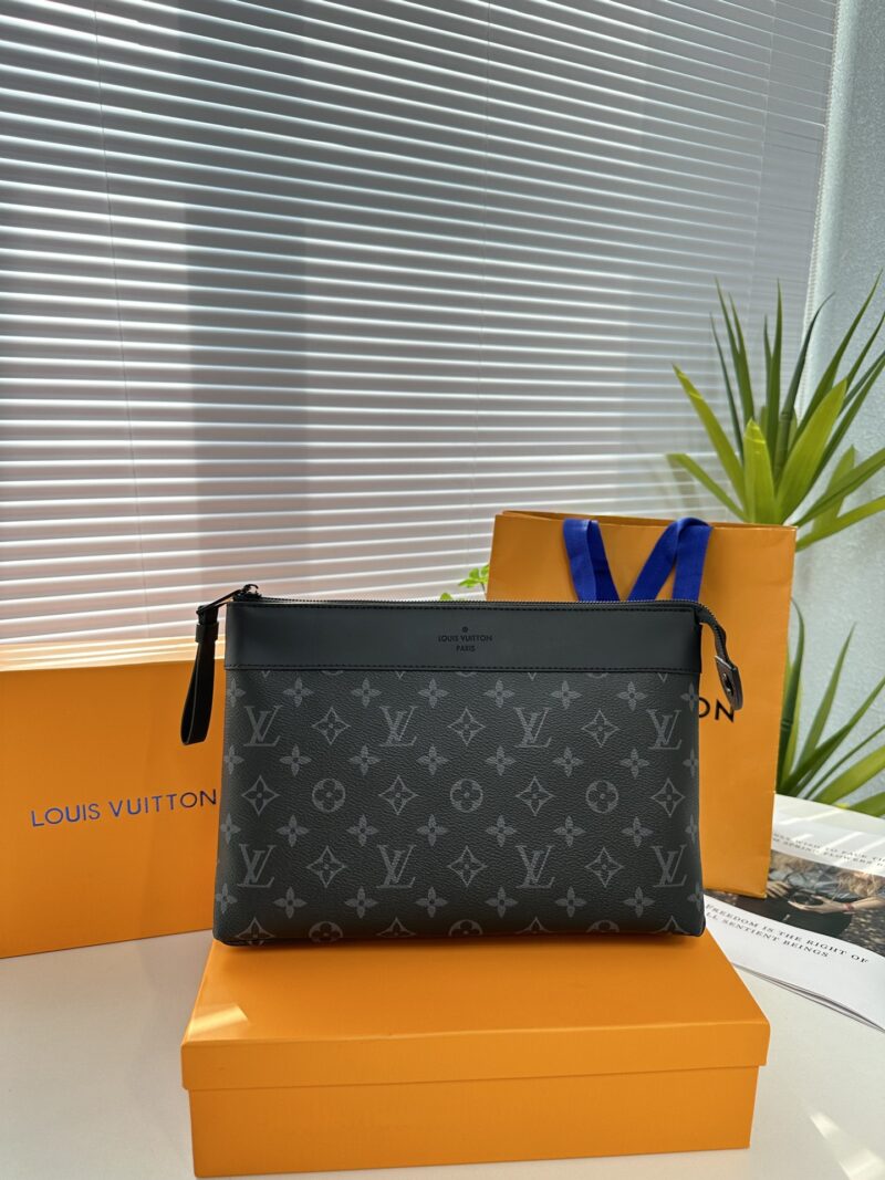 Exclusive real-life shot of M82543 black floral Pochette Voyage Souple handbag with gift box. Made of soft Monogram Eclipse coated canvas, the classic Pochette Voyage handbag lines are outlined with rounded strokes, providing a comfortable and portab...