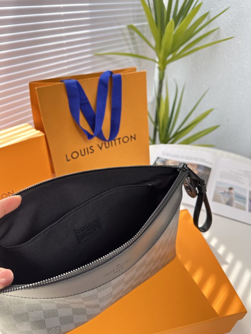 Exclusive real-life shot of M82543 Haige Pochette Voyage Souple handbag with packaging. Made of soft Monogram Eclipse coated canvas, the classic Pochette Voyage handbag lines are outlined with rounded strokes, providing a comfortable travel experienc...