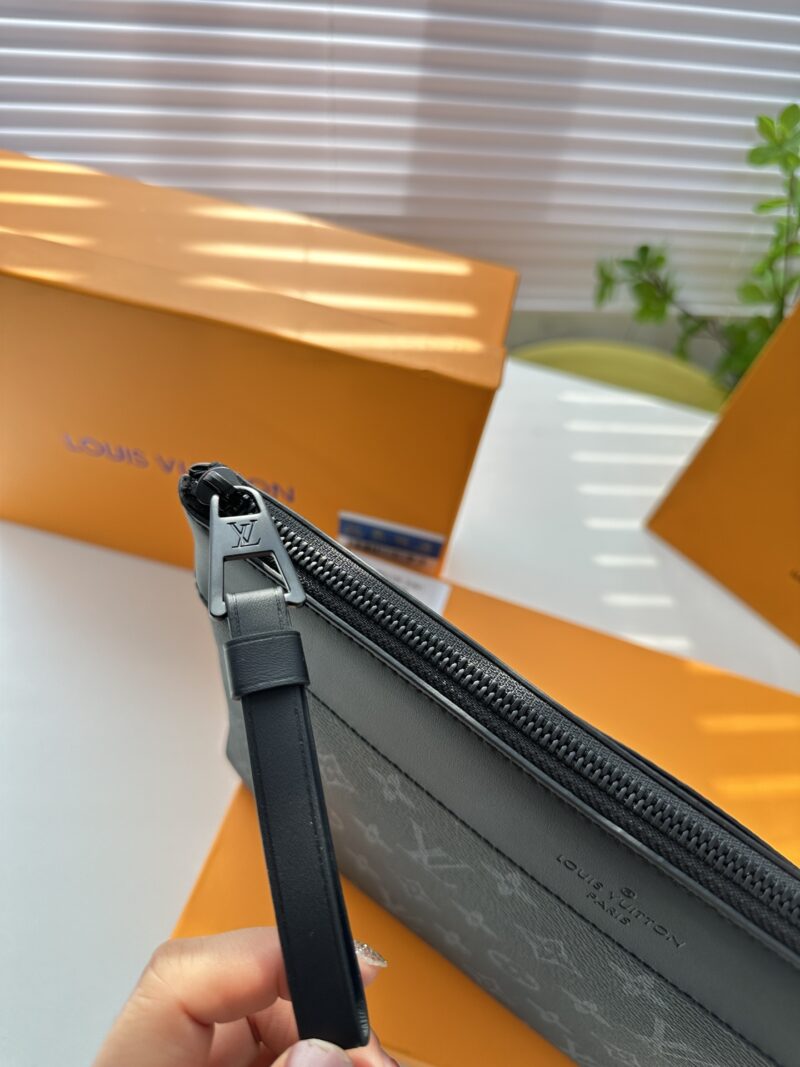 Exclusive real-life shot of M82543 black floral Pochette Voyage Souple handbag with gift box. Made of soft Monogram Eclipse coated canvas, the classic Pochette Voyage handbag lines are outlined with rounded strokes, providing a comfortable and portab...